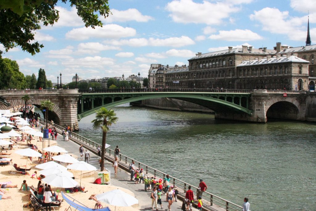The Georges-Pompidou expressway, opened in 1967 along the Seine, had been one of the busiest streets in Paris. 2002 marked the start of Paris-Plages (pictured here) when it was, and still is, transformed into a beach for six weeks every summer...but no diving or swimming in the river: c'est interdict!  Cars have been banned on the left bank roads since 2013.  In 2017, Anne Hidalgo, the mayor of Paris, achieved her dream of getting rid of one more major source of pollution and returning the right bank year round to the walkers, lovers, joggers, flaneurs, roller-bladers, bicyclists, tourists, et. al.
 Photo ©2013 Lito Bujanda-Moore 