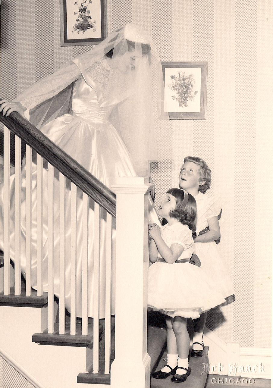 Flowergirls Ann James (Massey) and her cousin Sandy James admiring Ann's aunt and godmother, Ruth James Berdick, on her wedding day 1955