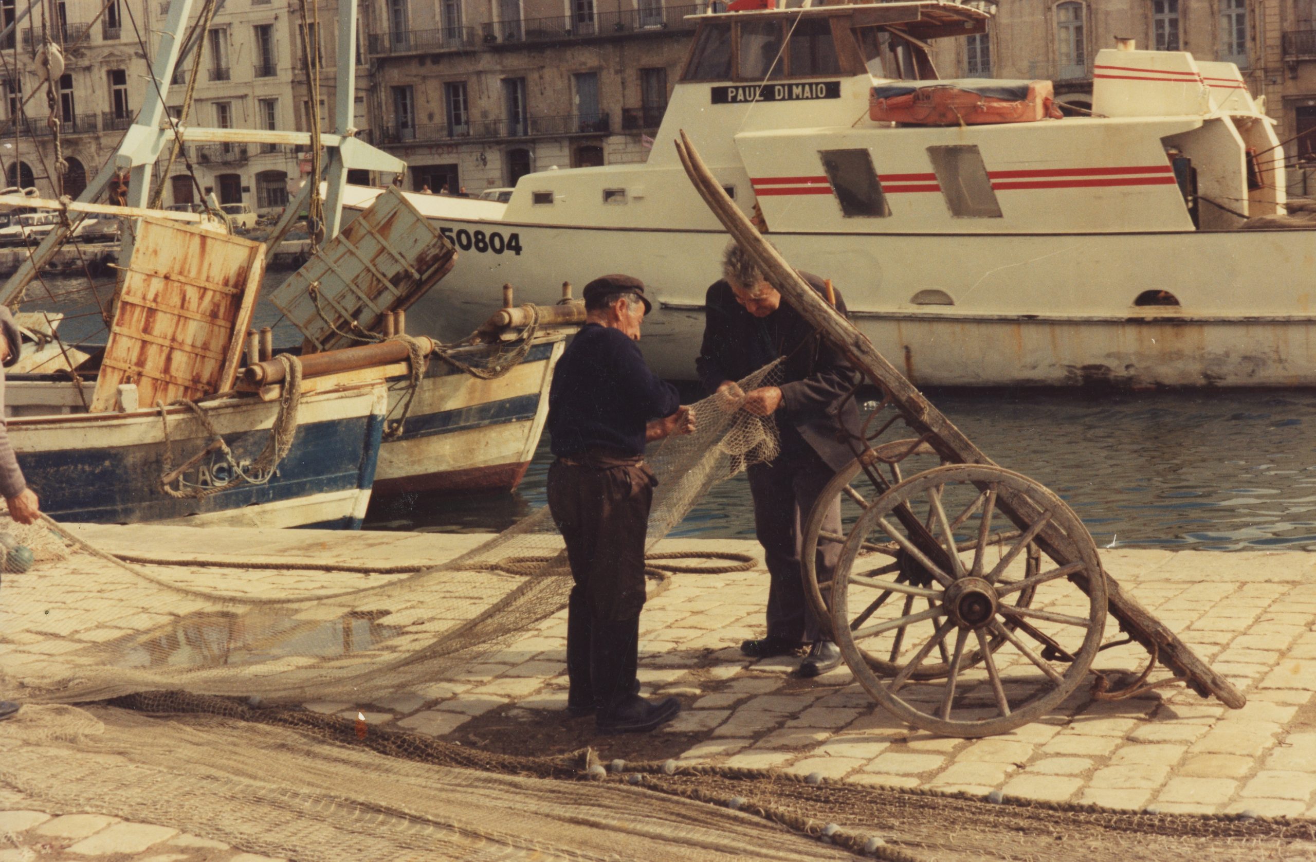 Séte in France. Also where I found my source material for the painting and the drawing: 
Fisherman Mending His Net.
Photo ©1976  Ann James Massey